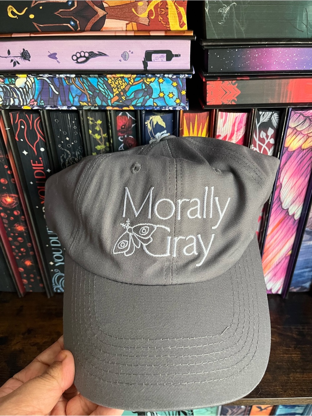 Morally Gray gray baseball cap with white text and moth graphic